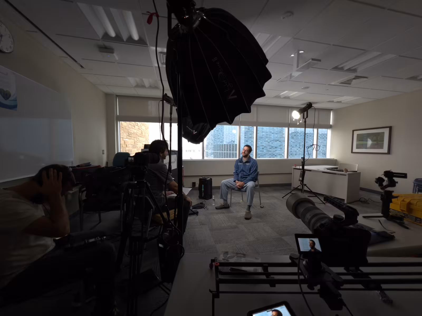 Interview lighting and camera setup inside a conference room during a corporate shoot