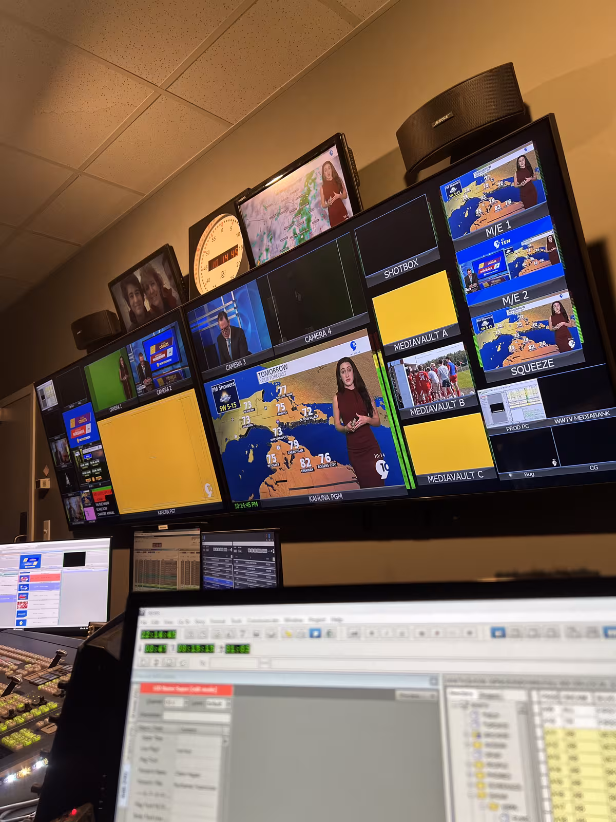 Television control room with a wall of monitors showing a live news broadcast
